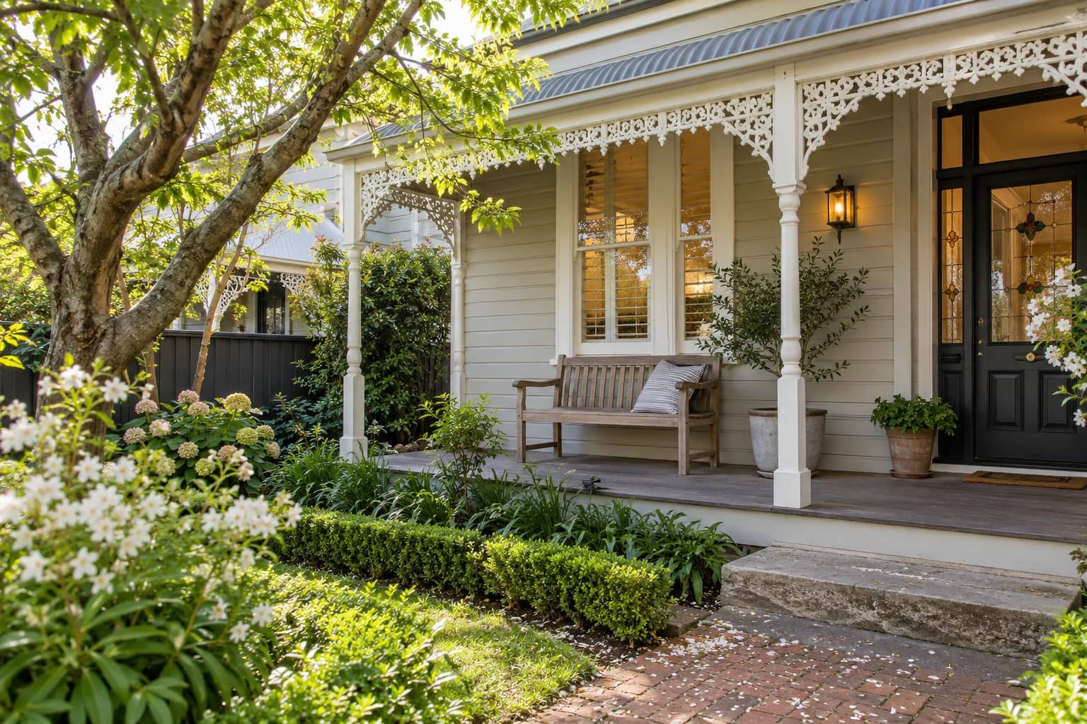 A weatherboard home veranda looking onto a small garden